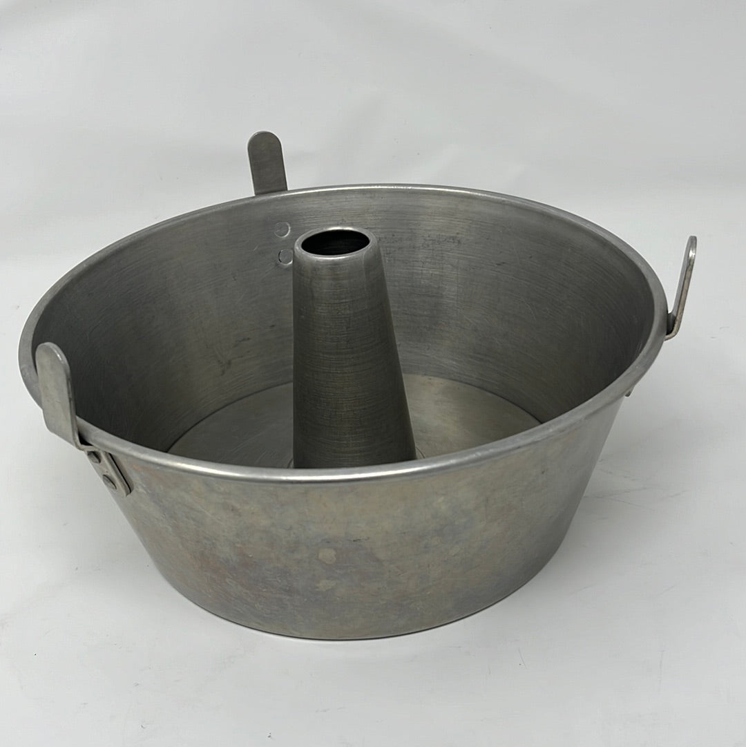A Mirro 5533M Angel Food Cake Pan with Cooling Feet, with a central tube, side handles, and spoons on a white background.
