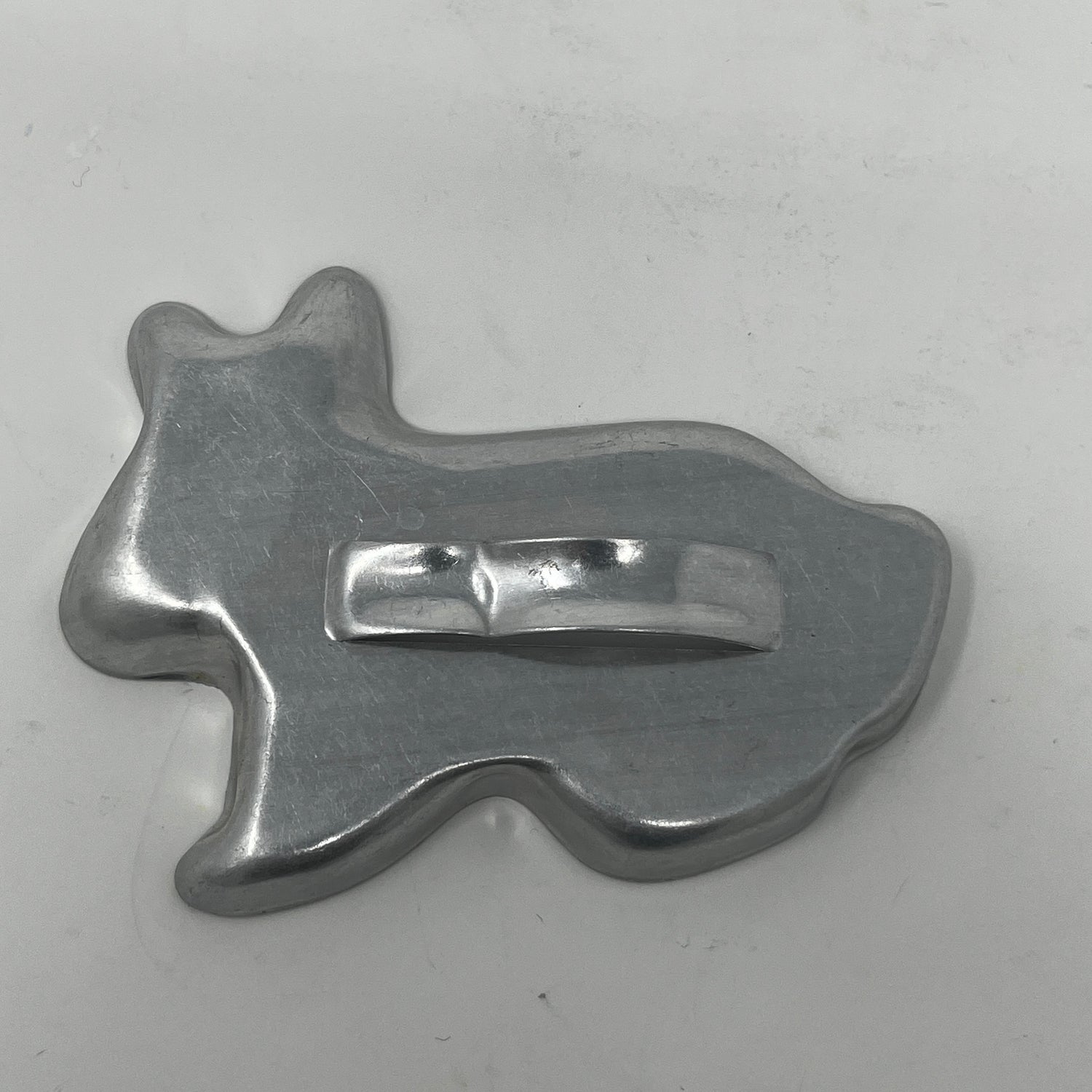 Mid-century metal cookie cutter with a large handle, ideal for easy gripping, part of a collection featuring holiday and celestial shapes, including rare 1930s designs.