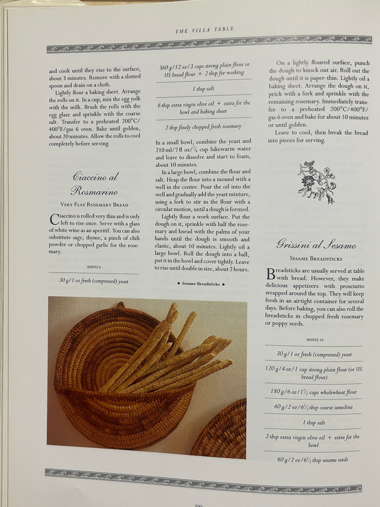 Cookbook page from The Villa Table featuring recipes for Italian-style breads: Ciccino al Rosmarino and Grissini al Sesamo, with a basket of breadsticks.