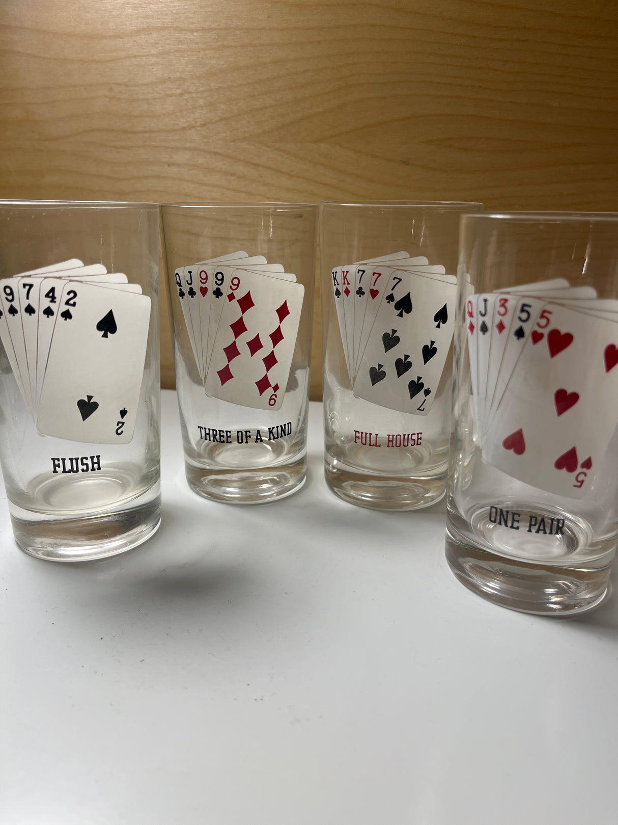 RARE 1960’s MCM poker-themed drinkware set with four clear shot glasses featuring different five-card poker hands like Flush and Full House.