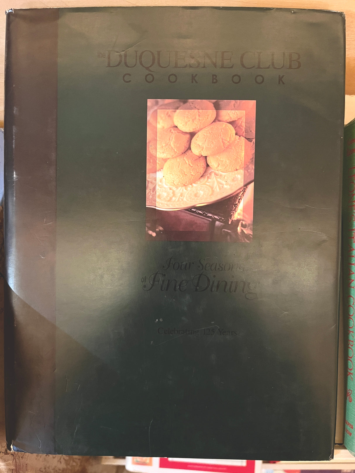 RARE Duquesne Club Cookbook: Front cover showcases Four Seasons of Fine Dining with a photo of biscuits on a decorative plate, celebrating 125 years.