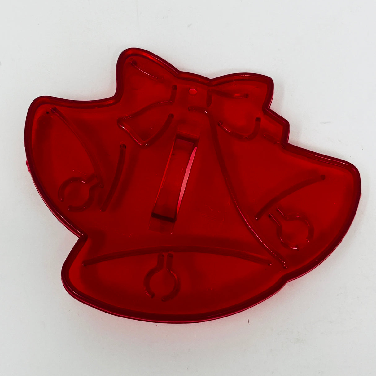 Red plastic mid century cookie cutters, including bell shapes and heart designs.