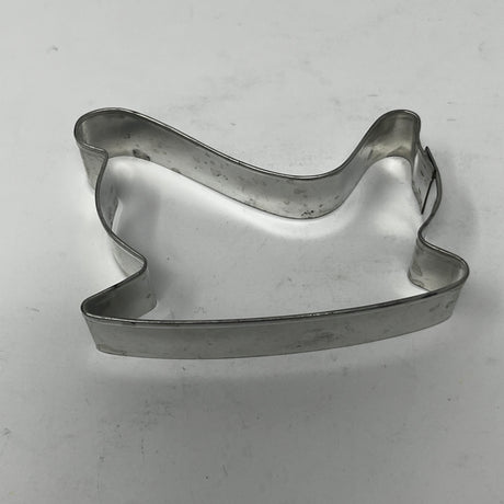 Mid-century metal cookie cutter on a white surface, designed for easy grip with a large handle, ideal for creating unique, collectible shapes.