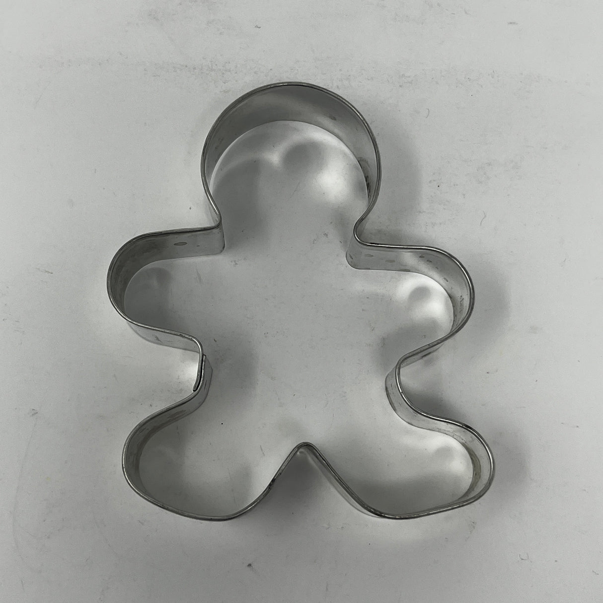 Mid century metal cookie cutter shaped like a man, designed for easy grip with a large handle, ideal for creating unique, rare cookie shapes.