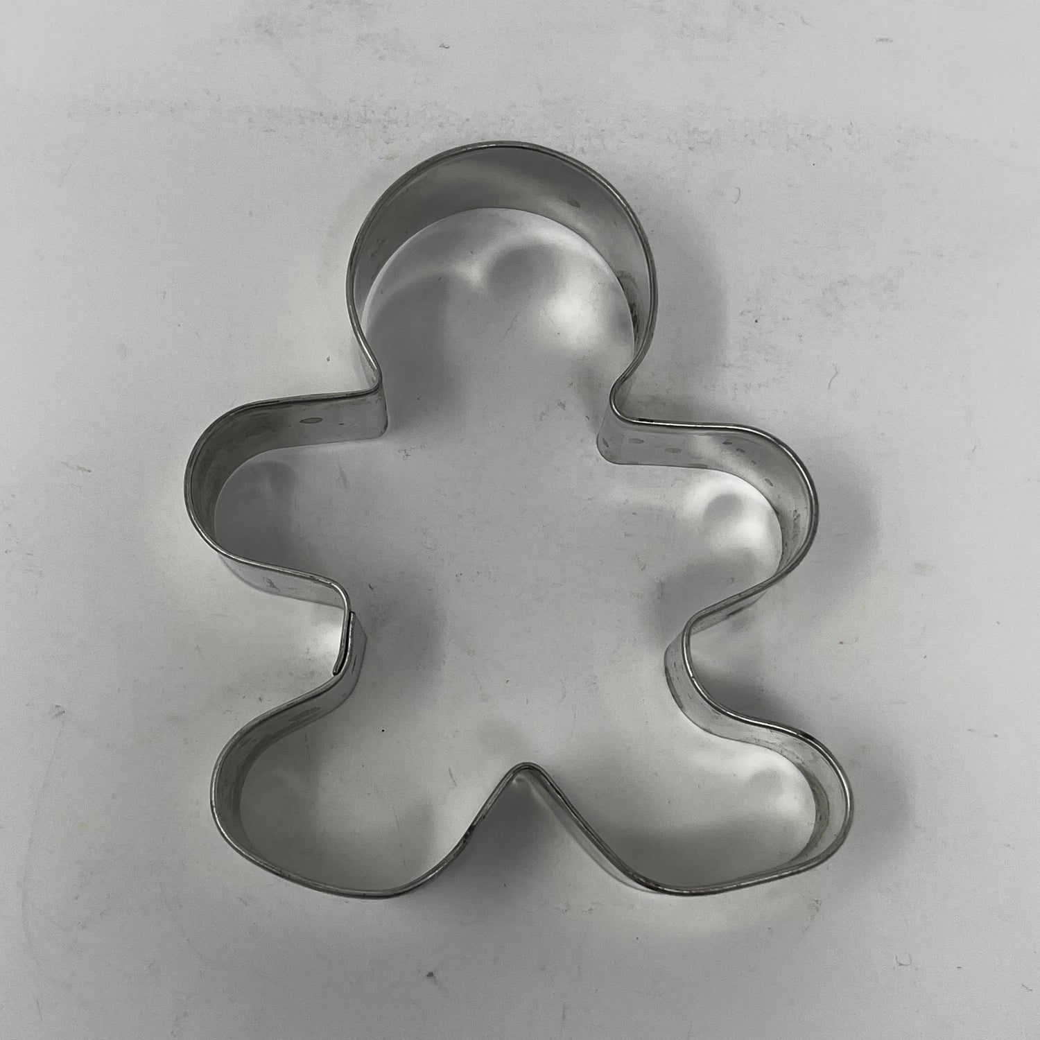 Mid century metal cookie cutter shaped like a man, designed for easy grip with a large handle, ideal for creating unique, rare cookie shapes.