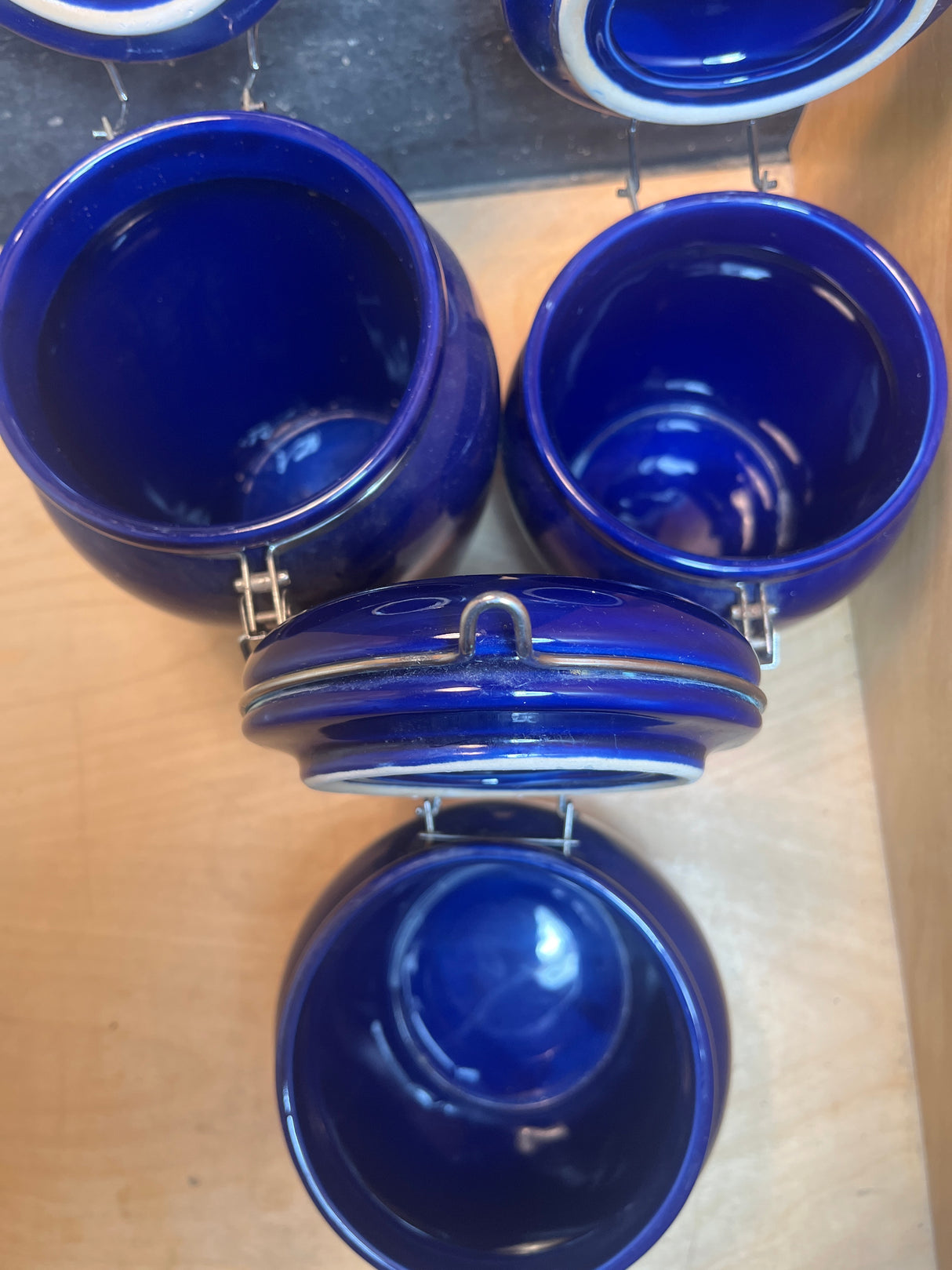 Set of 3 jars - cobalt blue ceramic with locking lids, displayed in a wooden rack, ideal for storing coffee, tea, or dry goods stylishly.