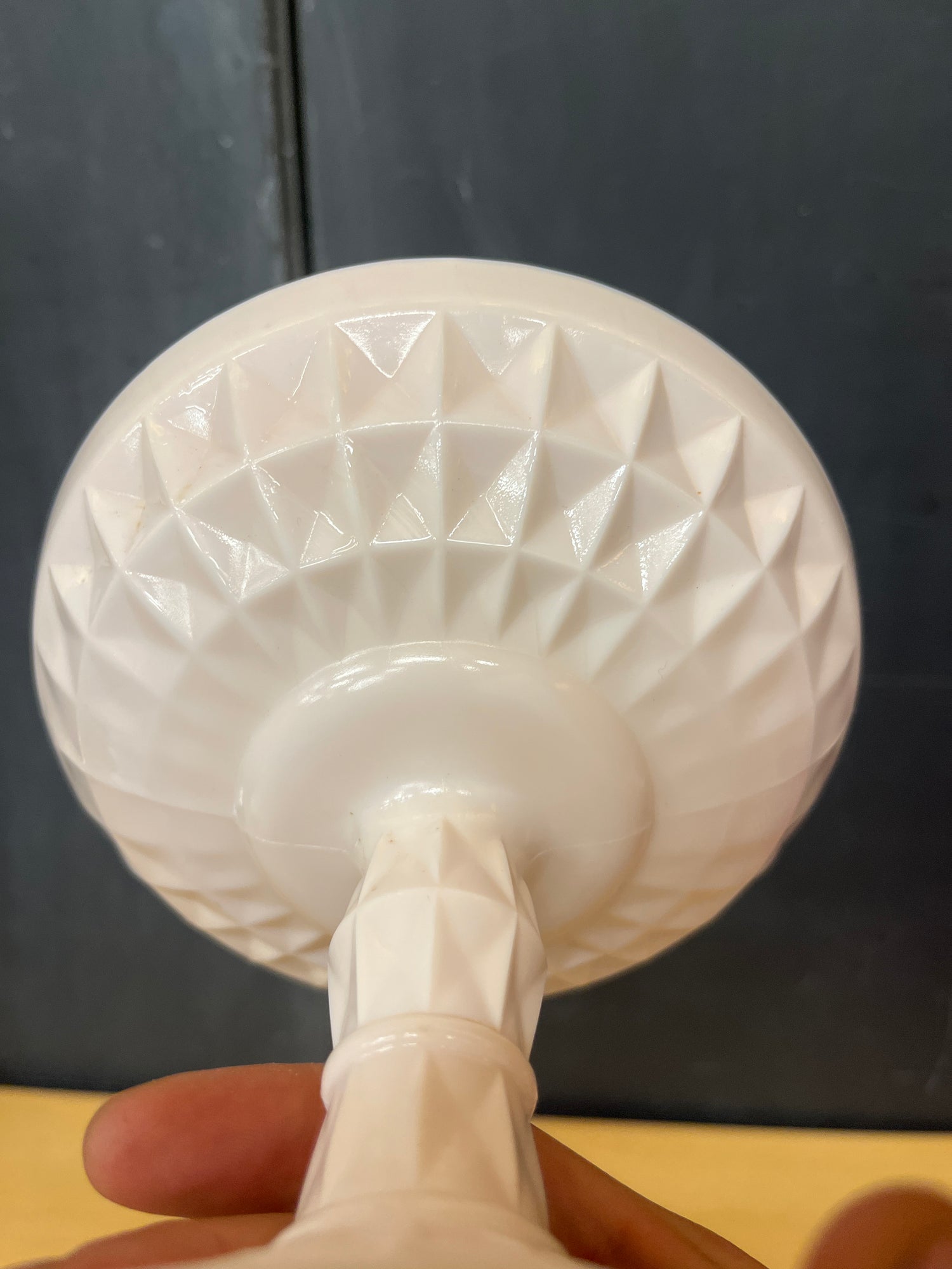 Jeanette pale pink milk glass pedestal candy dish with a geometric crisscross base and raised bump rim, showcasing vintage elegance and seamless manufacturing.