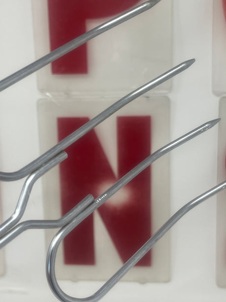 Close-up of vintage roast forks with wood handles, showcasing their stainless steel metal hooks, ideal for grilling meats and vegetables.