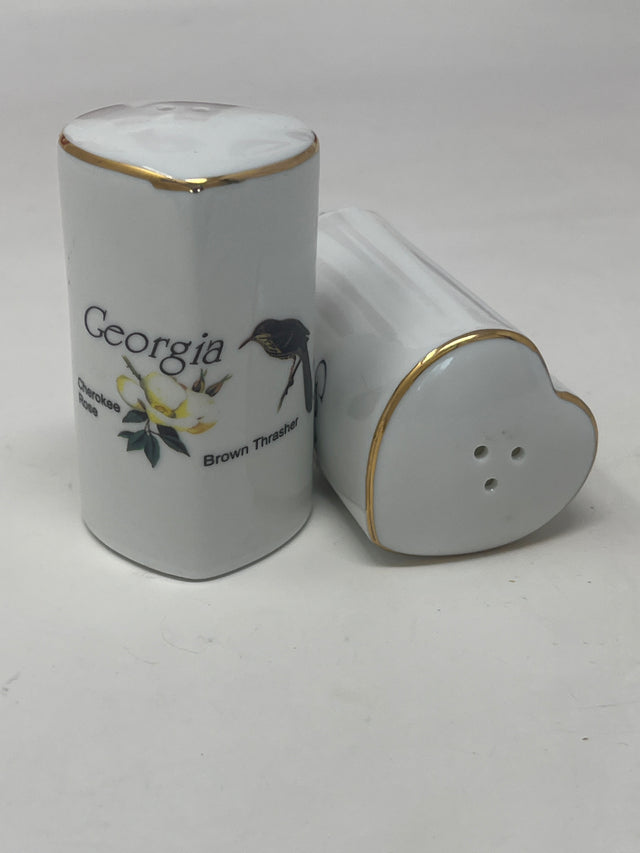 Ceramic heart-shaped salt and pepper shaker set with Georgia's Brown Thrasher and Cherokee Rose design, highlighting its intricate detailing and unique shape.