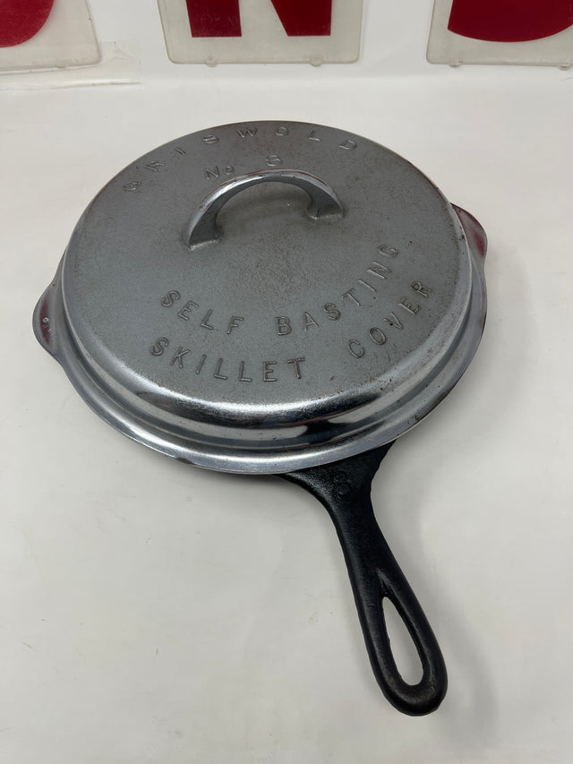 RARE antique Griswold No. 8 skillet and self-basting cover from the 1930s, displaying a cast-iron skillet with a chrome-plated lid, showing slight wear.