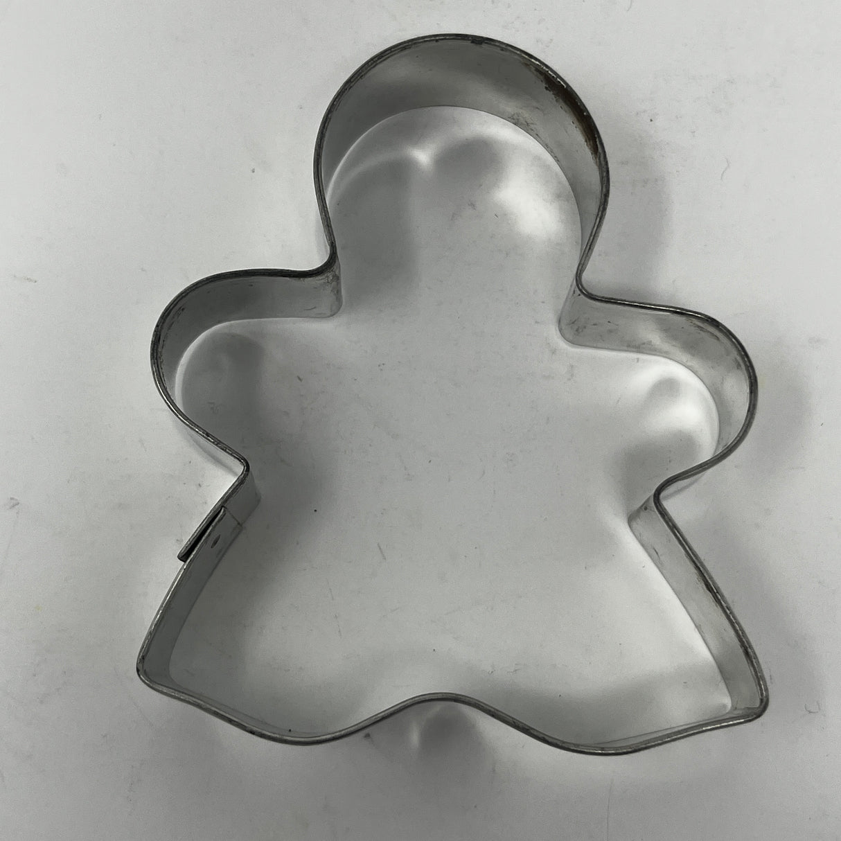 Mid-century metal cookie cutters with adaptive handles, including Christmas and celestial shapes, featuring rare designs like the 1930s Pillsbury's Comicooky Cutter.