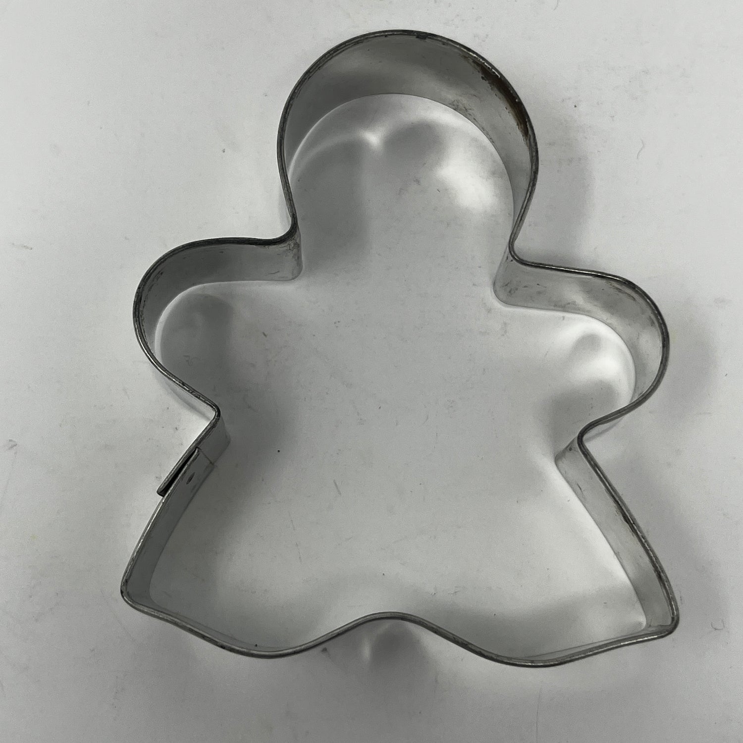 Mid-century metal cookie cutters with adaptive handles, including Christmas and celestial shapes, featuring rare designs like the 1930s Pillsbury's Comicooky Cutter.