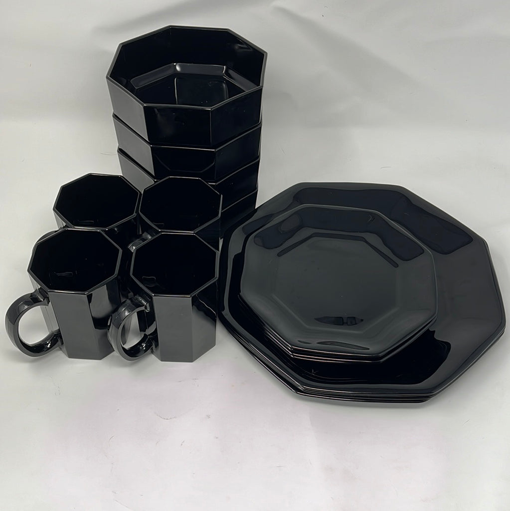 A sophisticated 16-piece black octagonal dishware set by Arcoroc, featuring glossy blown glass. Includes plates, cups, and bowls for elegant dining.