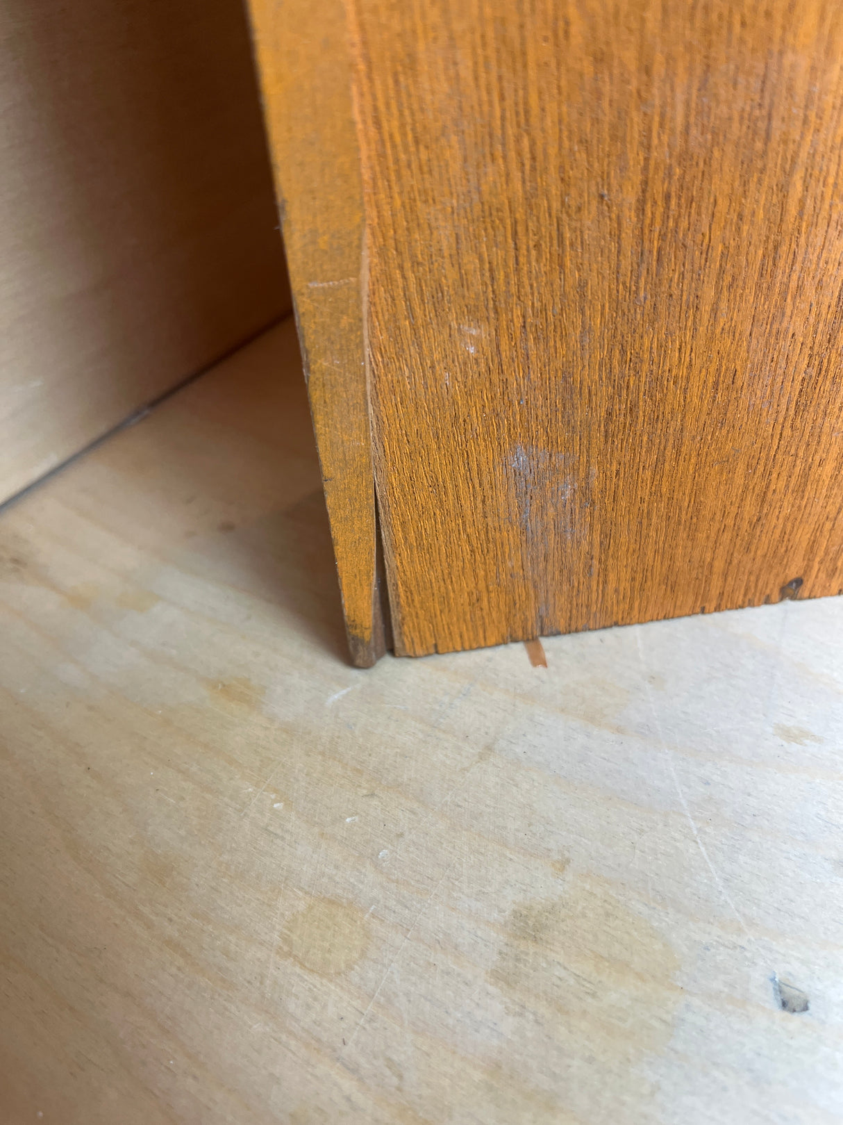 Funky floral wooden spice rack corner showing wear, with a loose veneer and old stain rings. Part of a set with 10 jars.
