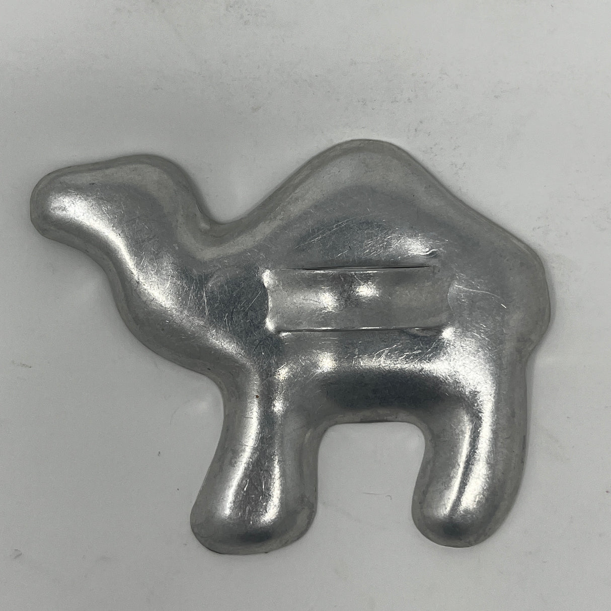 Mid century metal cookie cutter shaped like a camel, showcasing a sturdy design with a large handle for easy gripping.