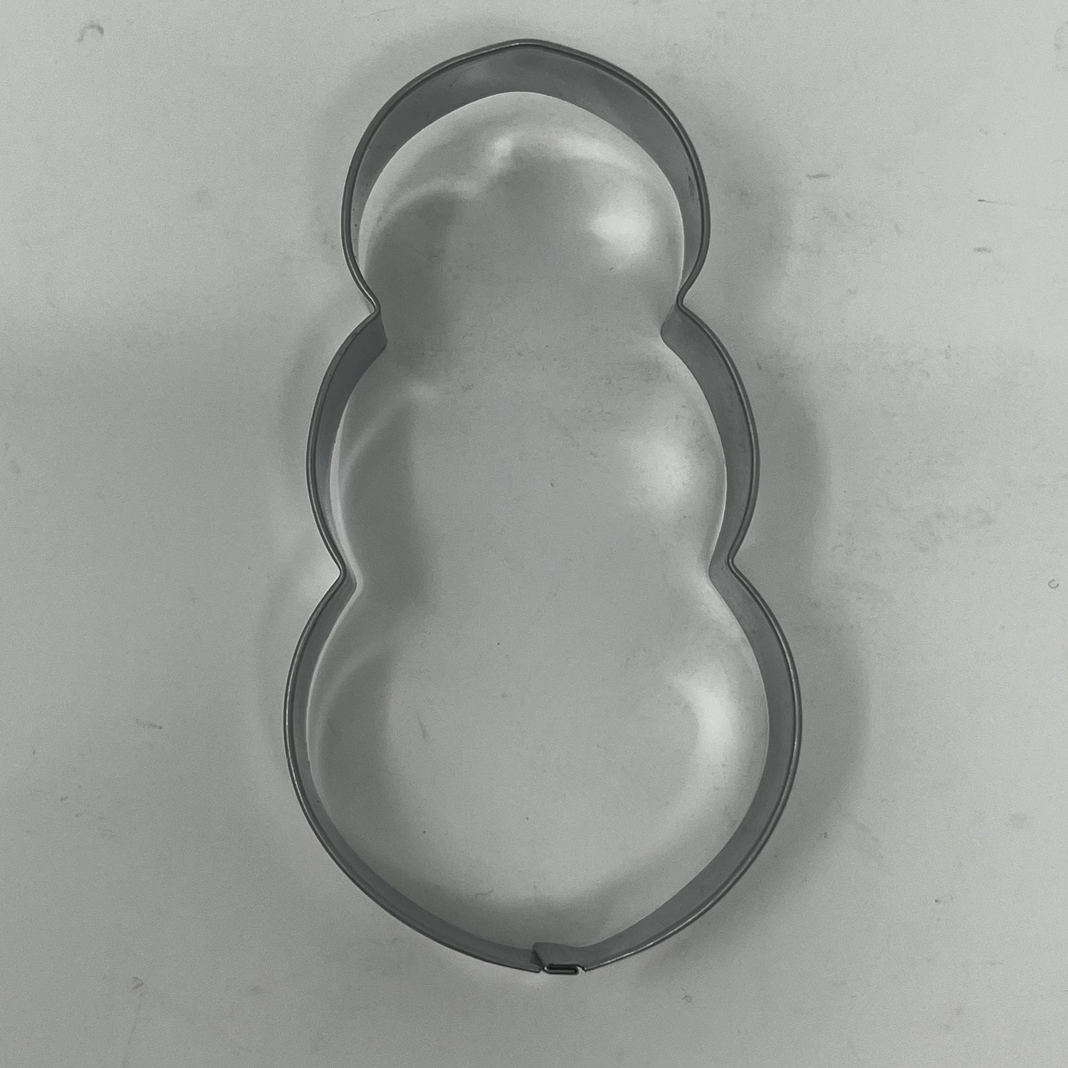 Mid century metal cookie cutters featuring adaptive designs with large handles, including Christmas and celestial shapes, some dating back to the 1930s.