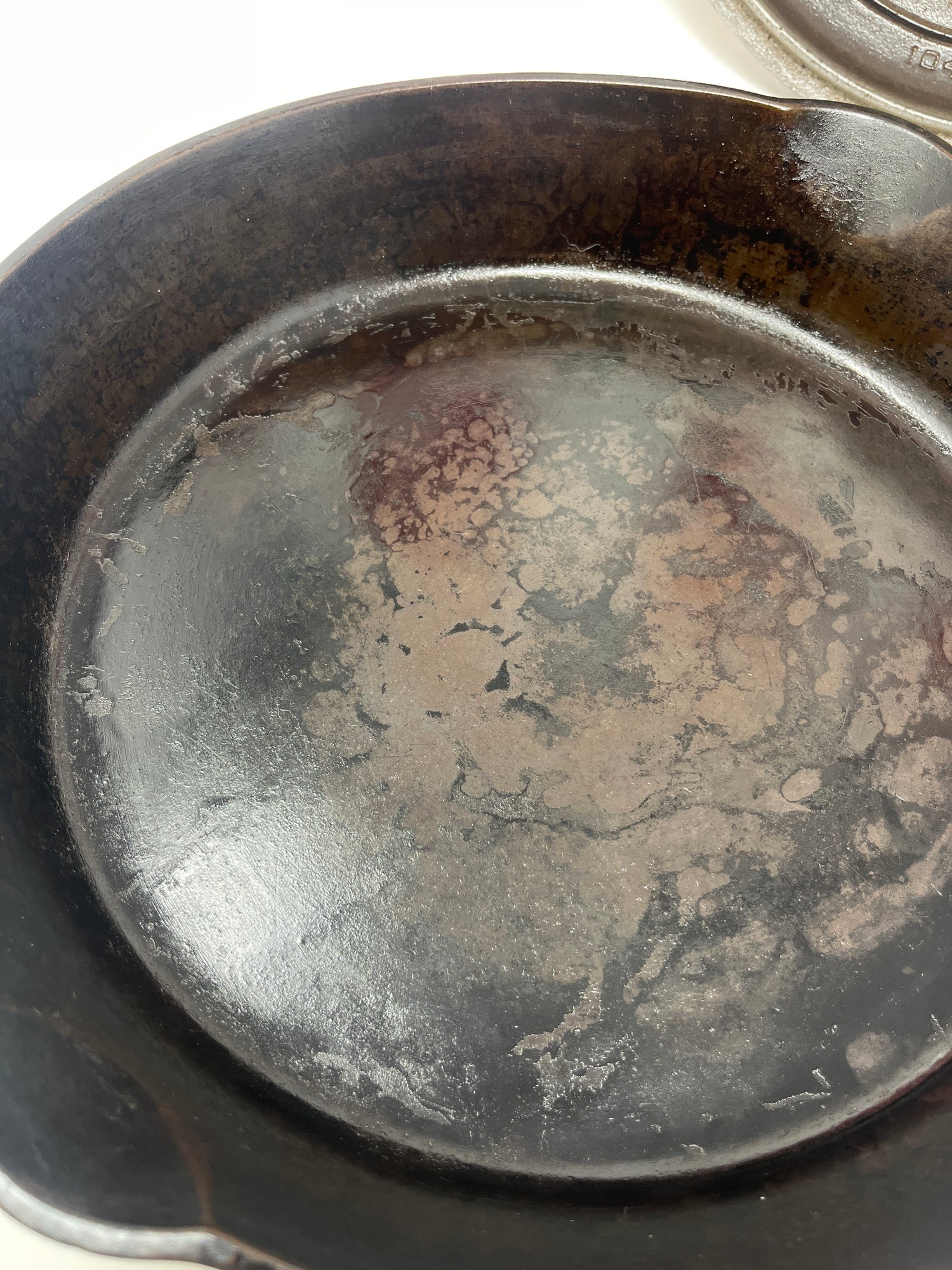 RARE antique Griswold No. 8 cast-iron skillet with self-basting chrome-plated lid, showcasing some surface wear and uneven seasoning, reflecting its historic Rust Belt origin.