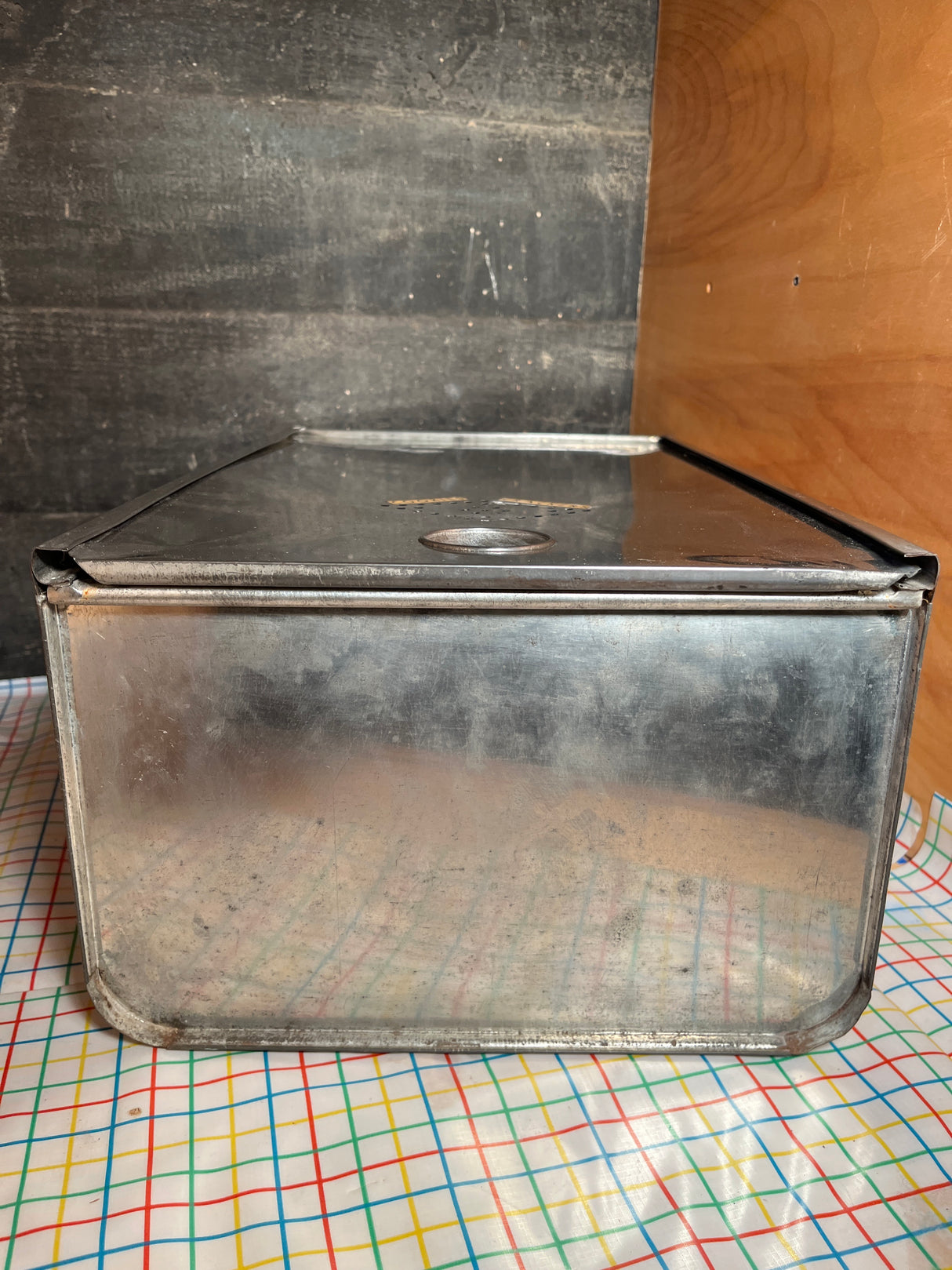 Bread box drawer insert with sliding lid, made of weathered, galvanized steel, featuring a hinged top and handmade labels, ideal for dry pantry storage.
