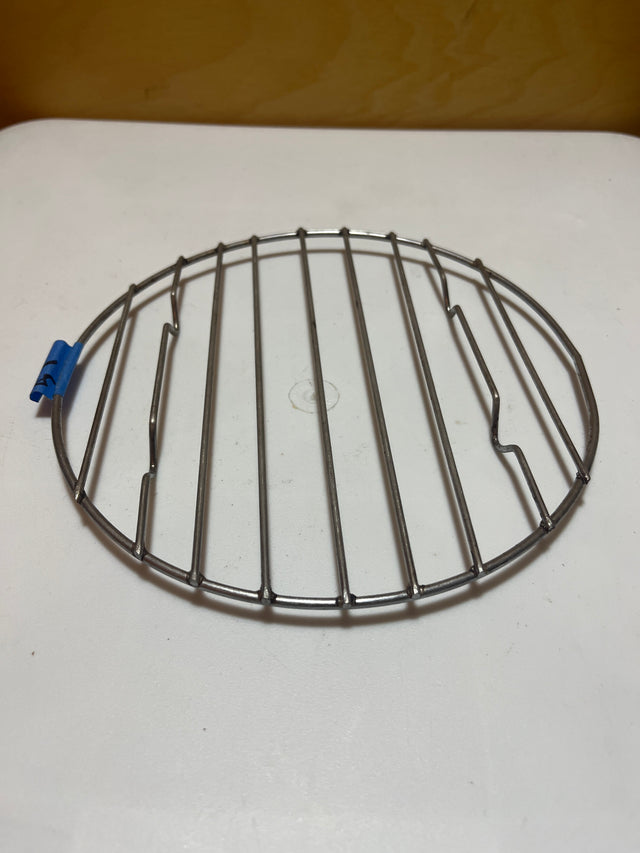 Small circular wire cooling rack with raised feet, versatile for use as a tray or cooling rack for pots and pans.
