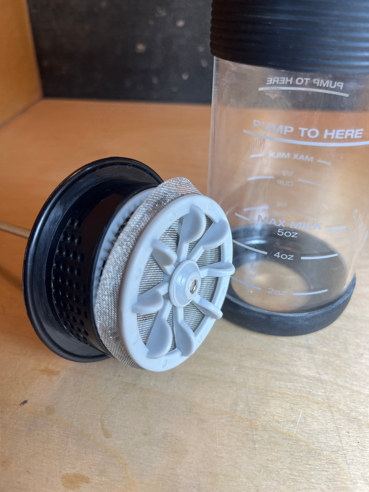 Ninja Easy Frother with mesh whisk assembly next to frothing jug, marked for optimal milk levels, designed for creamy hot or cold milk foam.