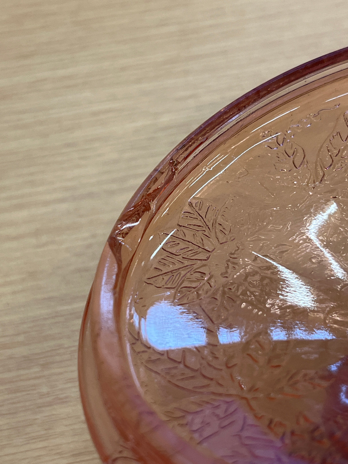 RARE Jeanette Depression glass candy jar with poinsettia motif, featuring a faceted footed bottom and ornate floral lid, highlighting a small chip on the inner lid.