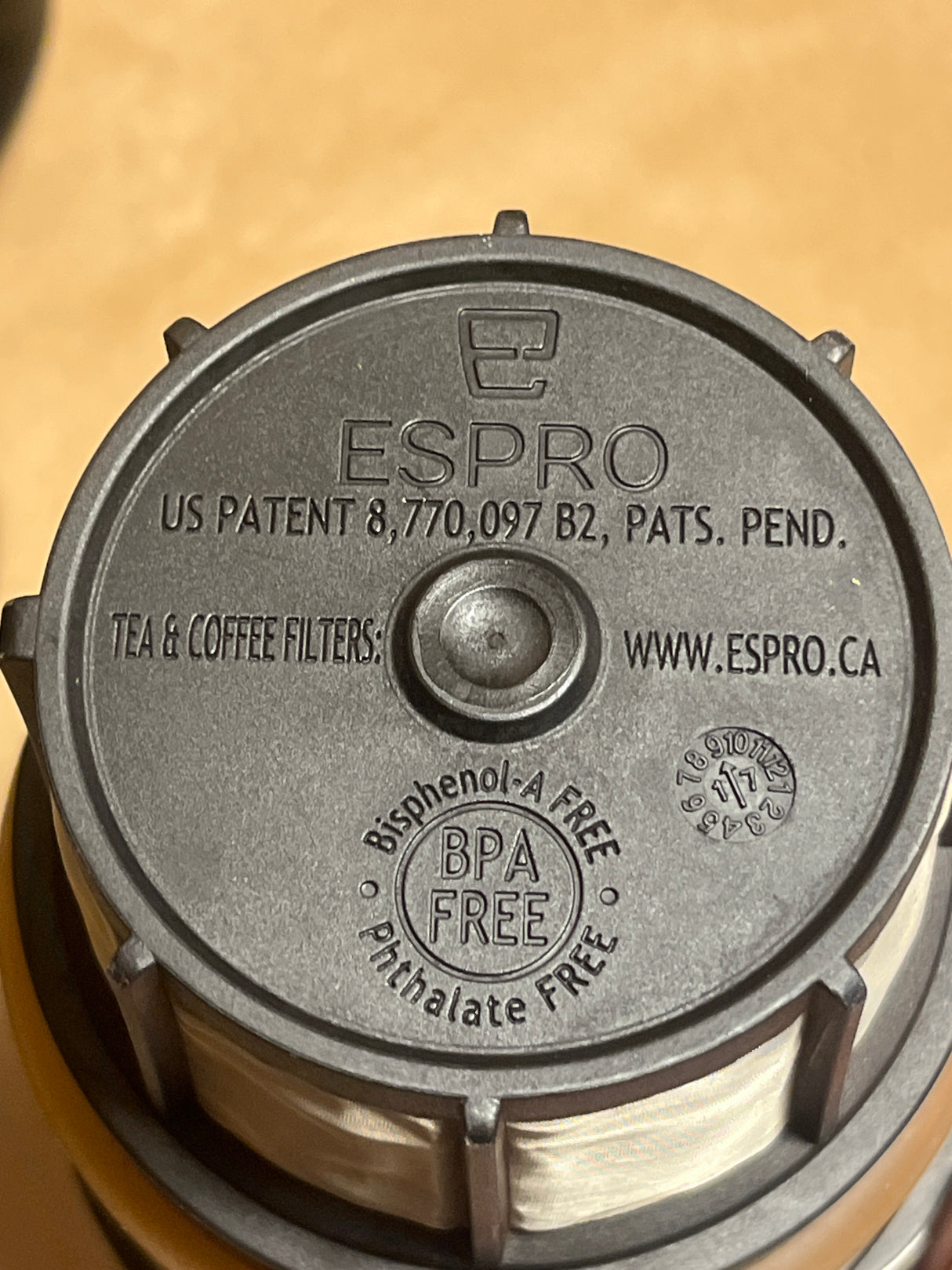 Espro filter-piston underside, showcasing the Espro logo, US patent 8,770,097 B2, BPA- and phthalate-free markings, and website, designed for their French-press style brewer.