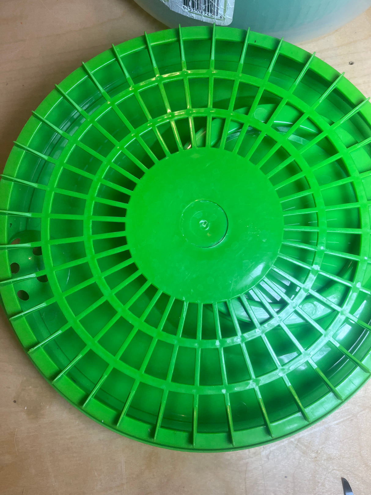 Salad spinner with handle and spout - Good Cook, featuring bright-green circular discs with a radial slotted pattern, designed for efficient water drainage and spinning.