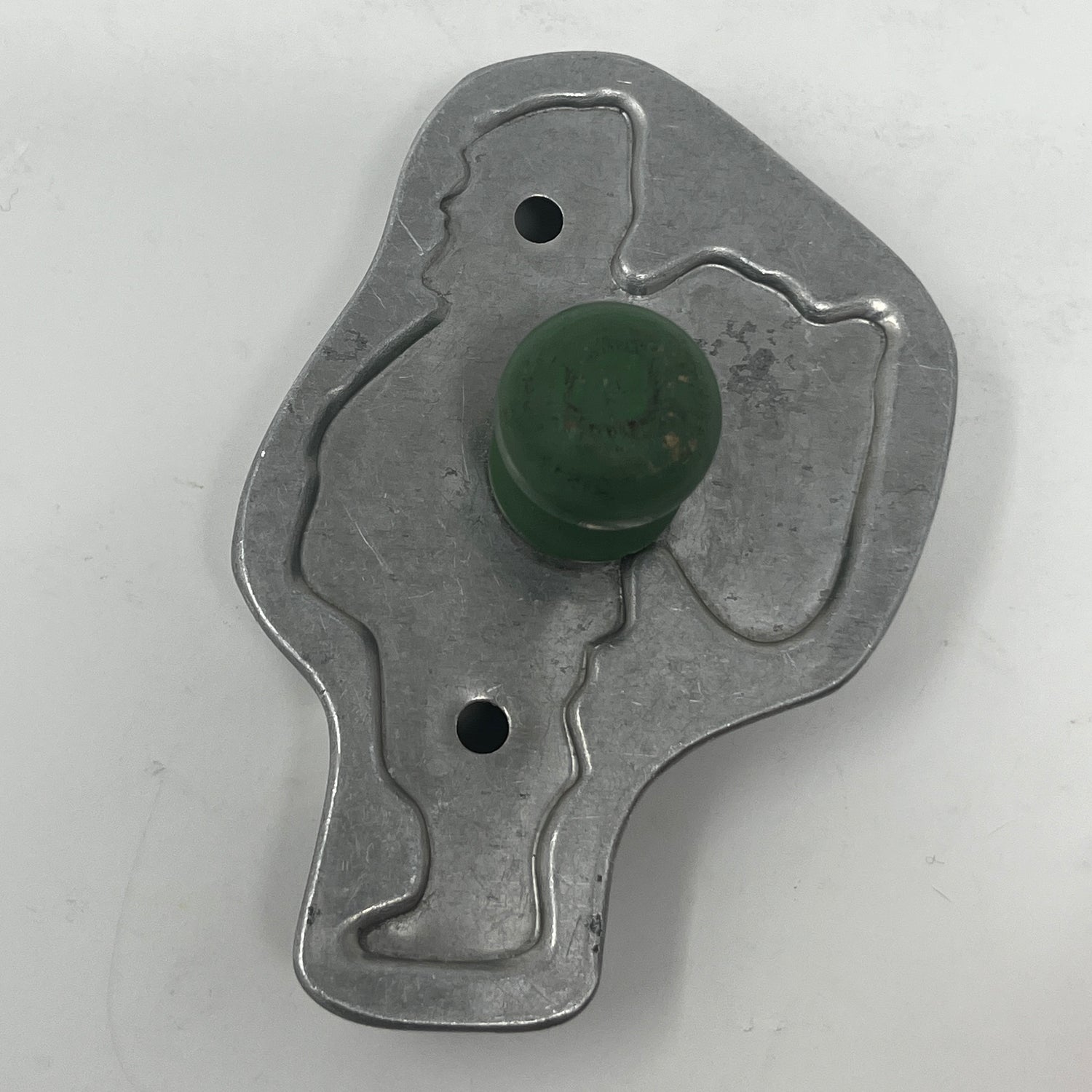 Mid-century metal cookie cutter with green knob, part of an adaptive collection featuring easy-to-grip handles and rare shapes from the 1930s.