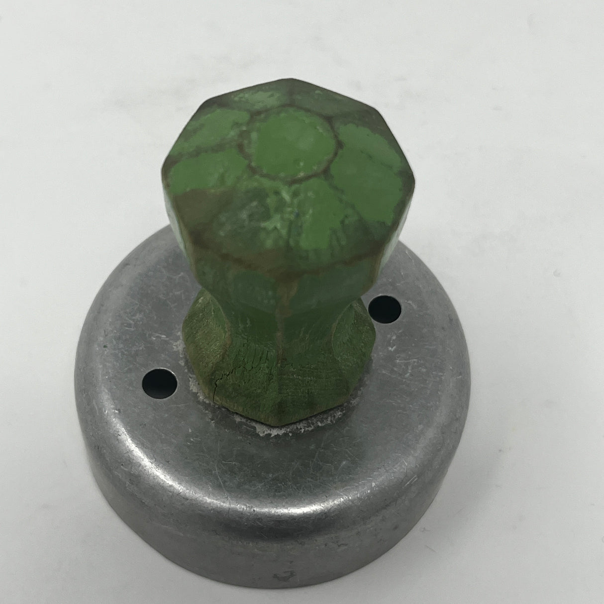 Mid century metal cookie cutters, including celestial and holiday shapes like moons and stars, feature large handles for easy gripping, some dating back to the 1930s.