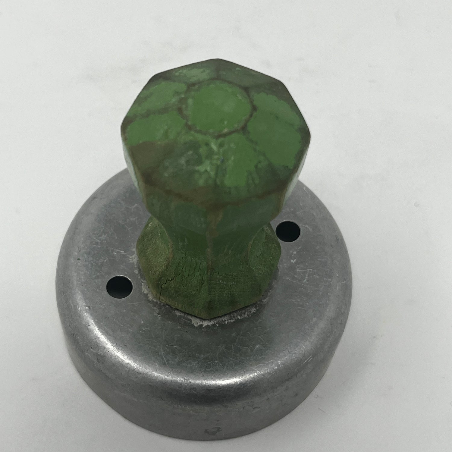 Mid century metal cookie cutters, including celestial and holiday shapes like moons and stars, feature large handles for easy gripping, some dating back to the 1930s.