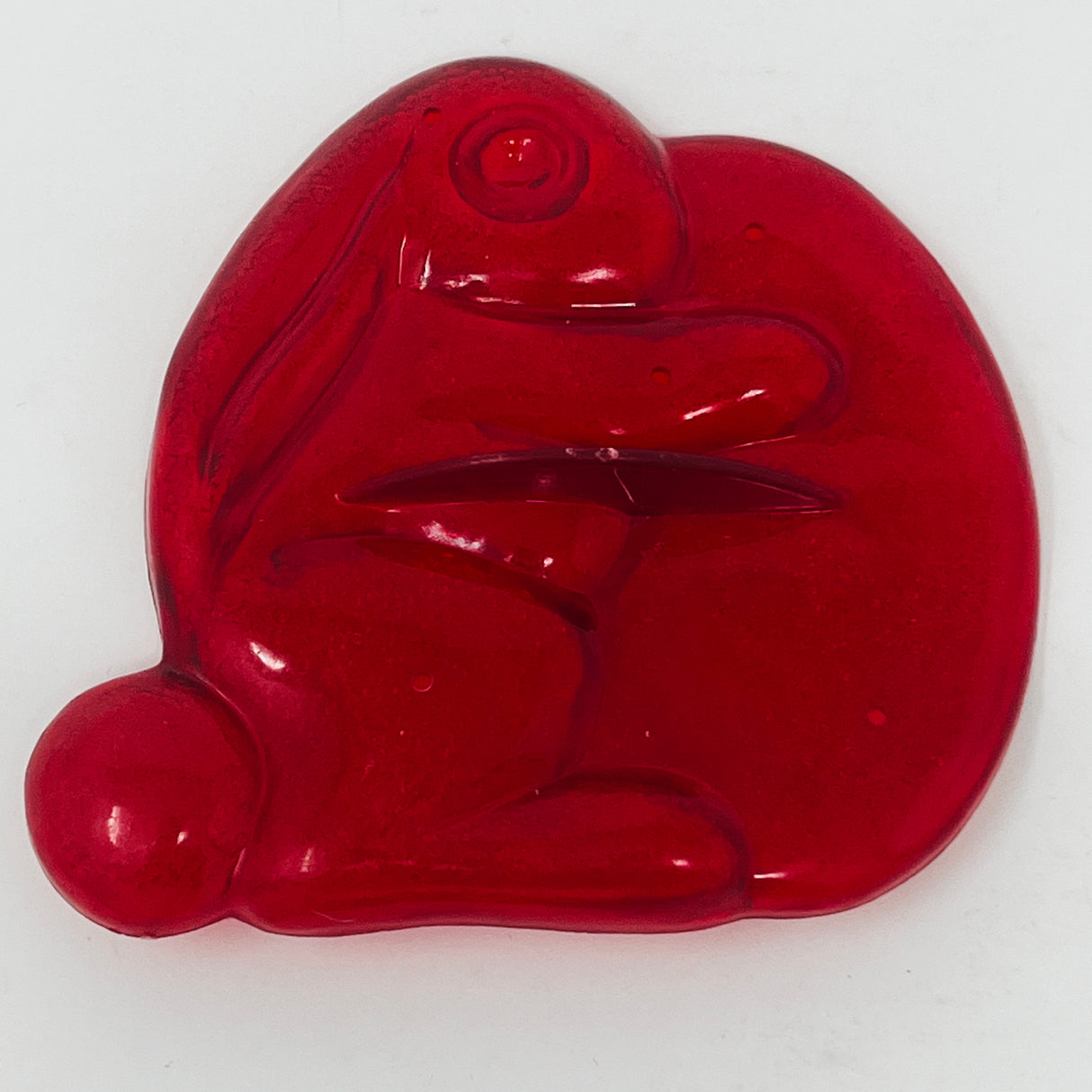 Red plastic mid century cookie cutters shaped like a frog and other objects.