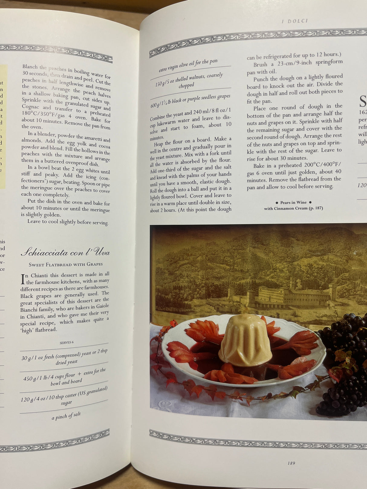 The Villa Table cookbook open to Dolci section, showcasing peach dessert, Schiacciata con l’Uva, and a photo of Pears in Wine with Cinnamon Cream.