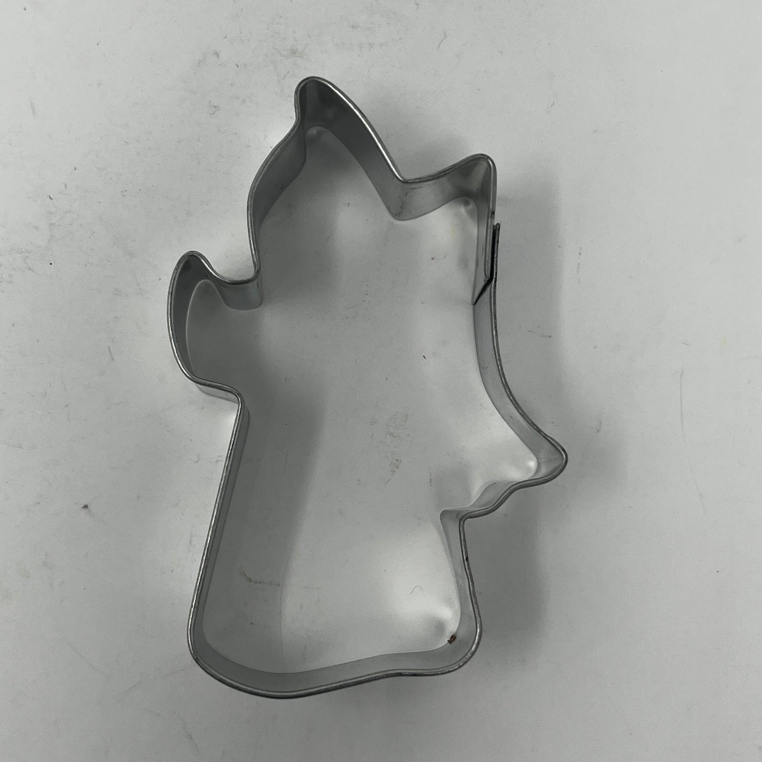 Mid-century metal cookie cutters featuring adaptive handles, showcasing various shapes from Christmas themes to stars and moons, including rare 1930s designs like Pillsbury's Comicooky Cutter.