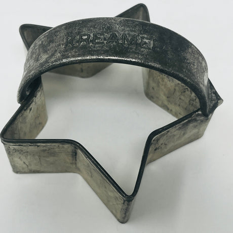 Mid-century metal star-shaped cookie cutter, part of a collection with ergonomic handles for easy grip, featuring designs from the 1930s.