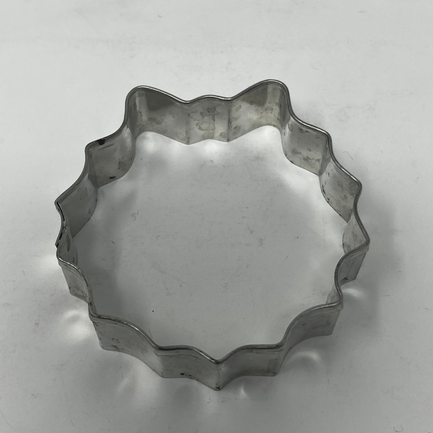 Mid-century metal cookie cutter, ideal for adaptive use with a large handle, perfect for creating unique shapes like moons and stars.