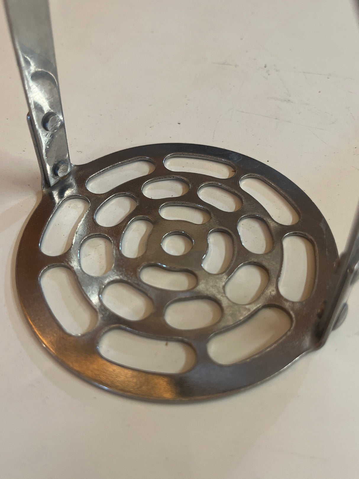 Potato masher with black handle, features an easy-grip design and hanging notch, combining vintage charm with practical utility for effective mashing.