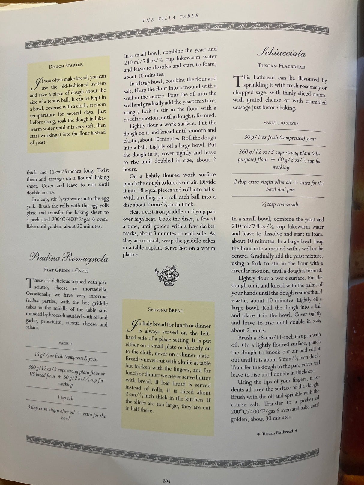 Open cookbook The Villa Table on page 204, featuring recipes for Piadina Romagnola and Schiacciata, with ingredient lists, methods, and serving suggestions.