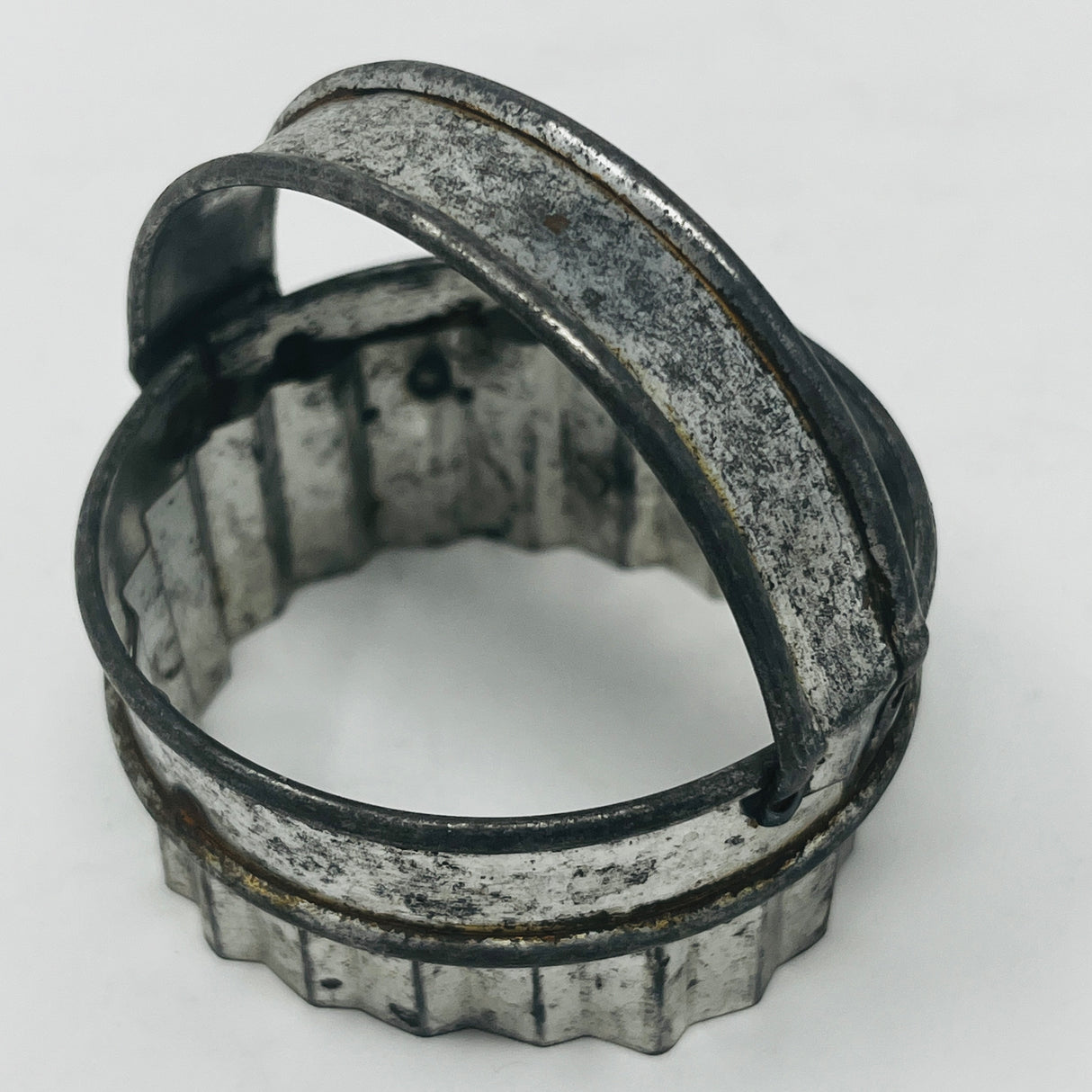 Mid-century metal cookie cutter with a sturdy handle, designed for ease of use, part of a collection featuring Christmas and celestial shapes from the 1930s.