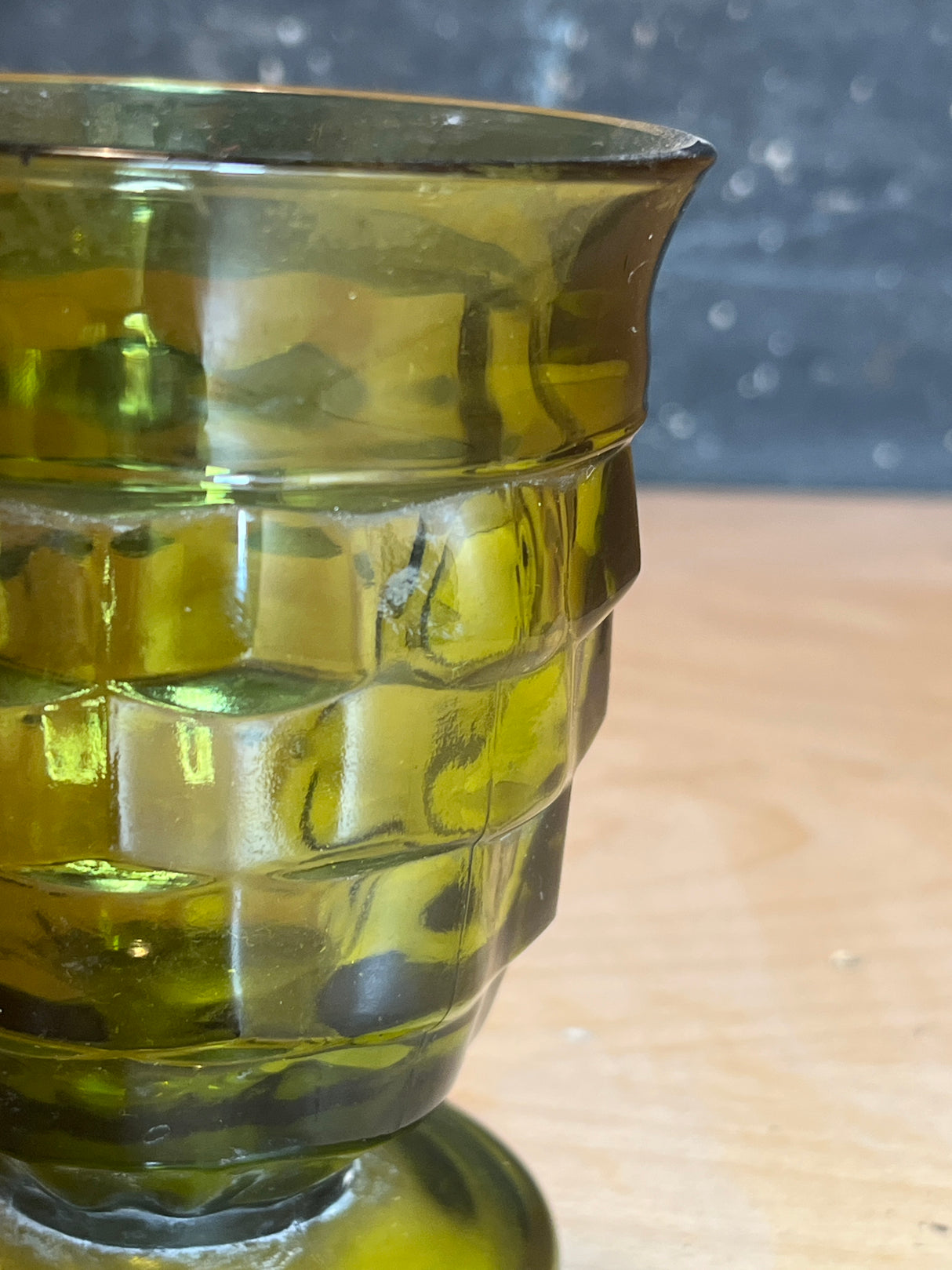 Whitehall Indiana green cubist glass goblet, a vintage-style, translucent olive-green vessel with a faceted texture, featuring a short pedestal base.