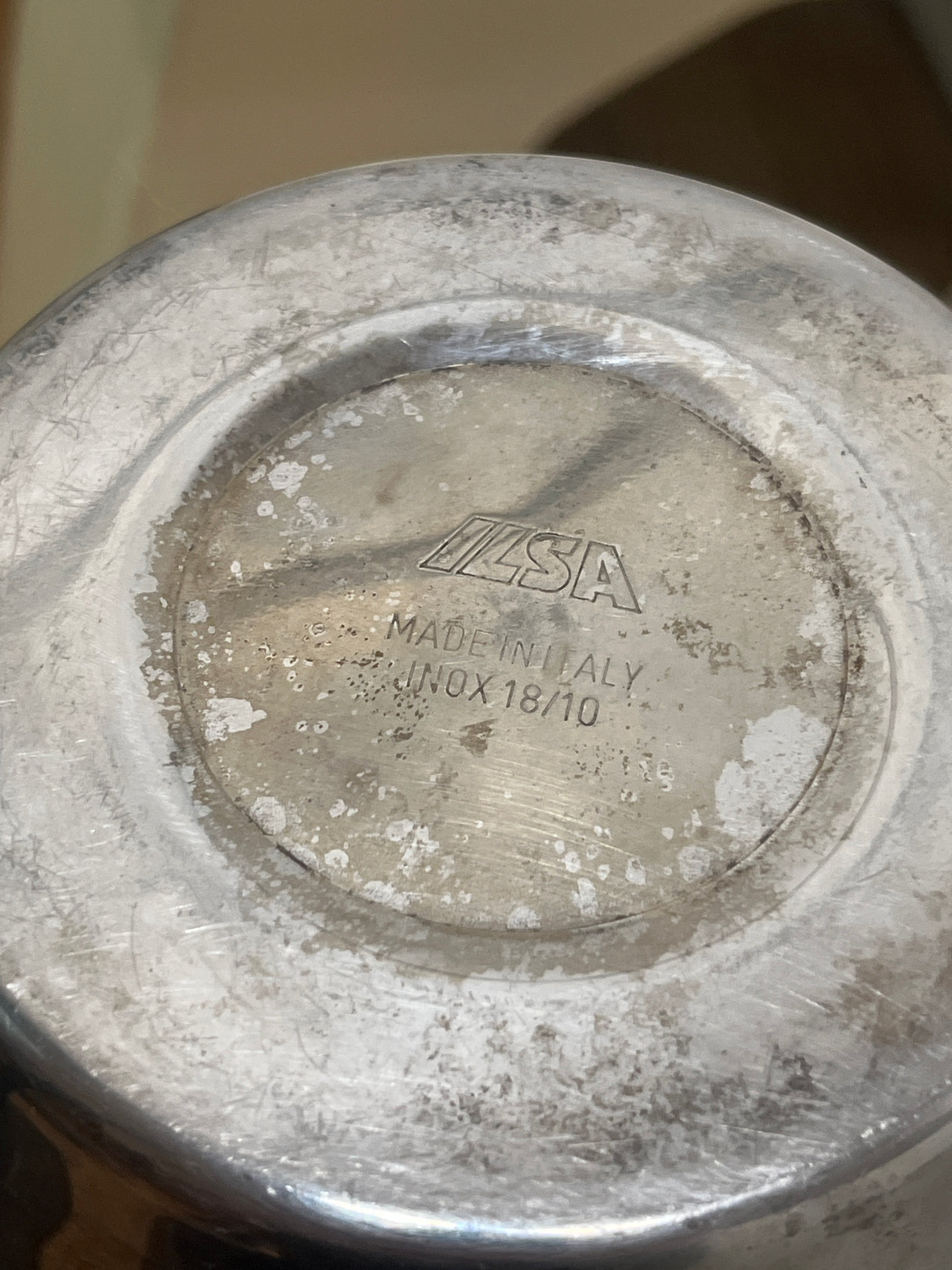 Ilsa Turbo Express 6-Cup 18/10 stainless steel stovetop espresso pot underside, showing ILSA logo, Made in Italy, minor wear, spotting, and mineral deposits.