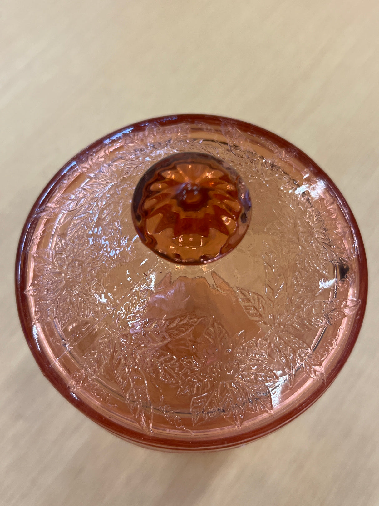 RARE Jeanette Depression glass pink floral poinsettia candy jar with lid, featuring a faceted footed base and ornate floral motifs, in good condition with a minor lid chip.