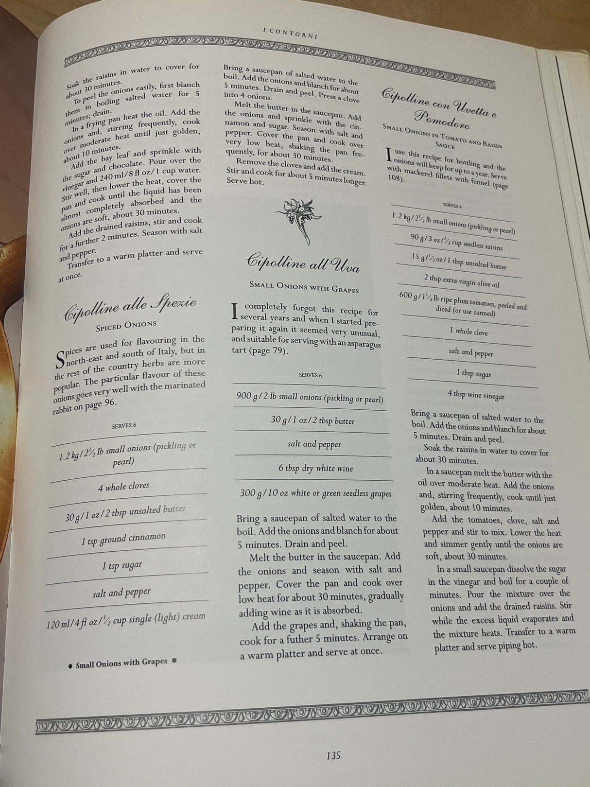The Villa Table cookbook spread on page 135 showcases three cipolline recipes: Spiced Onions, Onions with Grapes, and Onions in Tomato-Raisin Sauce.