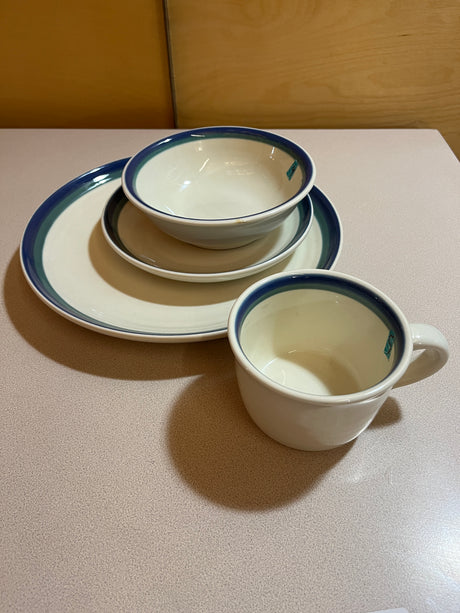 Pfaltzgraff Ocean Breeze dinnerware set displayed with plates and bowls featuring coastal-inspired designs, showcasing elegant craftsmanship and a modern aesthetic.
