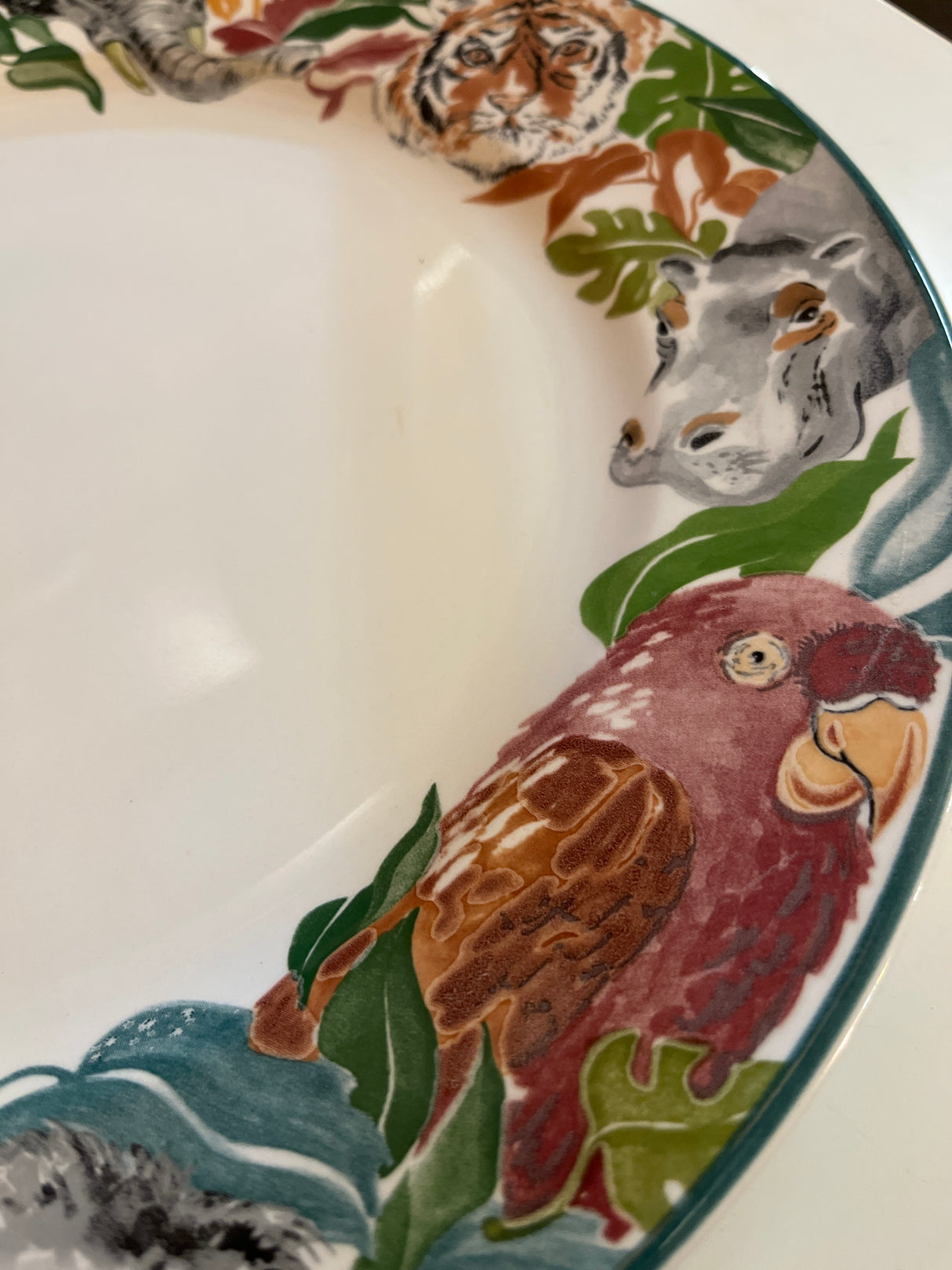 Jungle Fever dinner plate - Sango 3033 designed by Deborah Mallow, featuring a macaw, hippo, tiger, and elephant motifs on the rim.