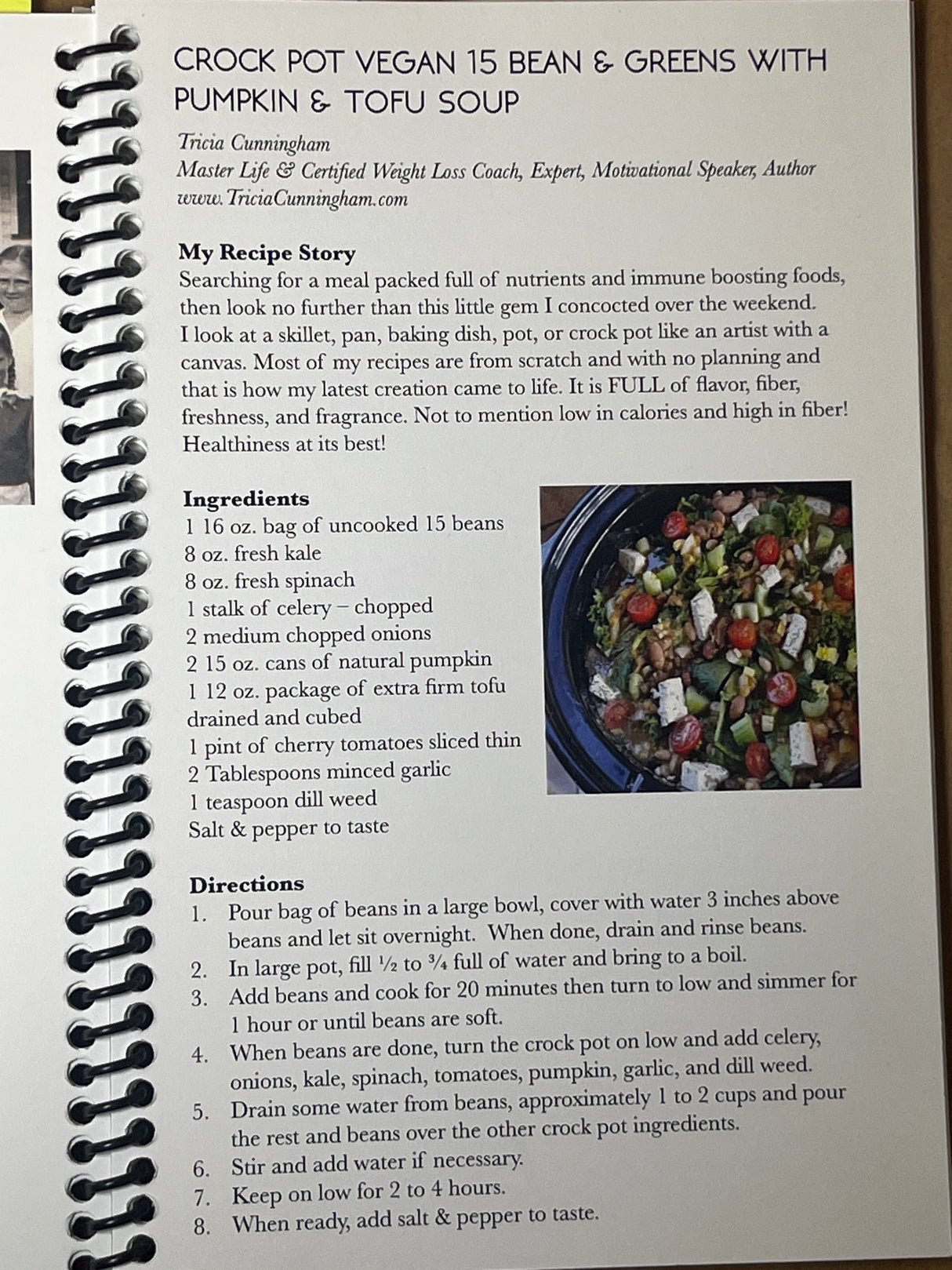 Spiral-bound recipe booklet featuring Crock Pot Vegan 15 Bean & Greens with Pumpkin & Tofu Soup by Tricia Cunningham, includes ingredients, preparation steps, and a photo of the soup.
