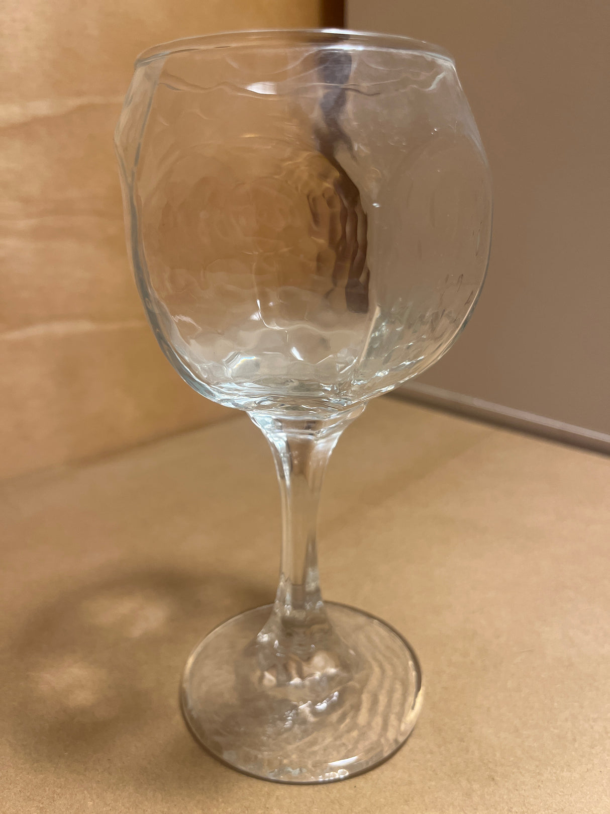 Libbey Chivalry glassware featuring a hammered-texture bowl, elegantly displayed upright on a countertop, showcasing its unique design and craftsmanship.