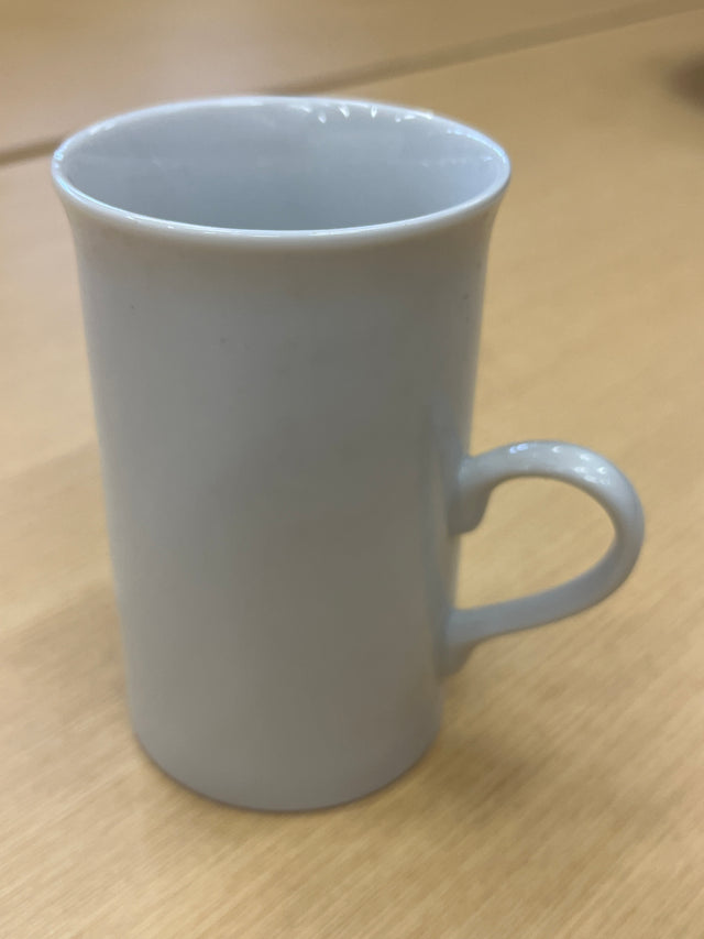Tall ceramic white coffee mug with a smooth finish and delicate, modern handle, perfect for everyday use.