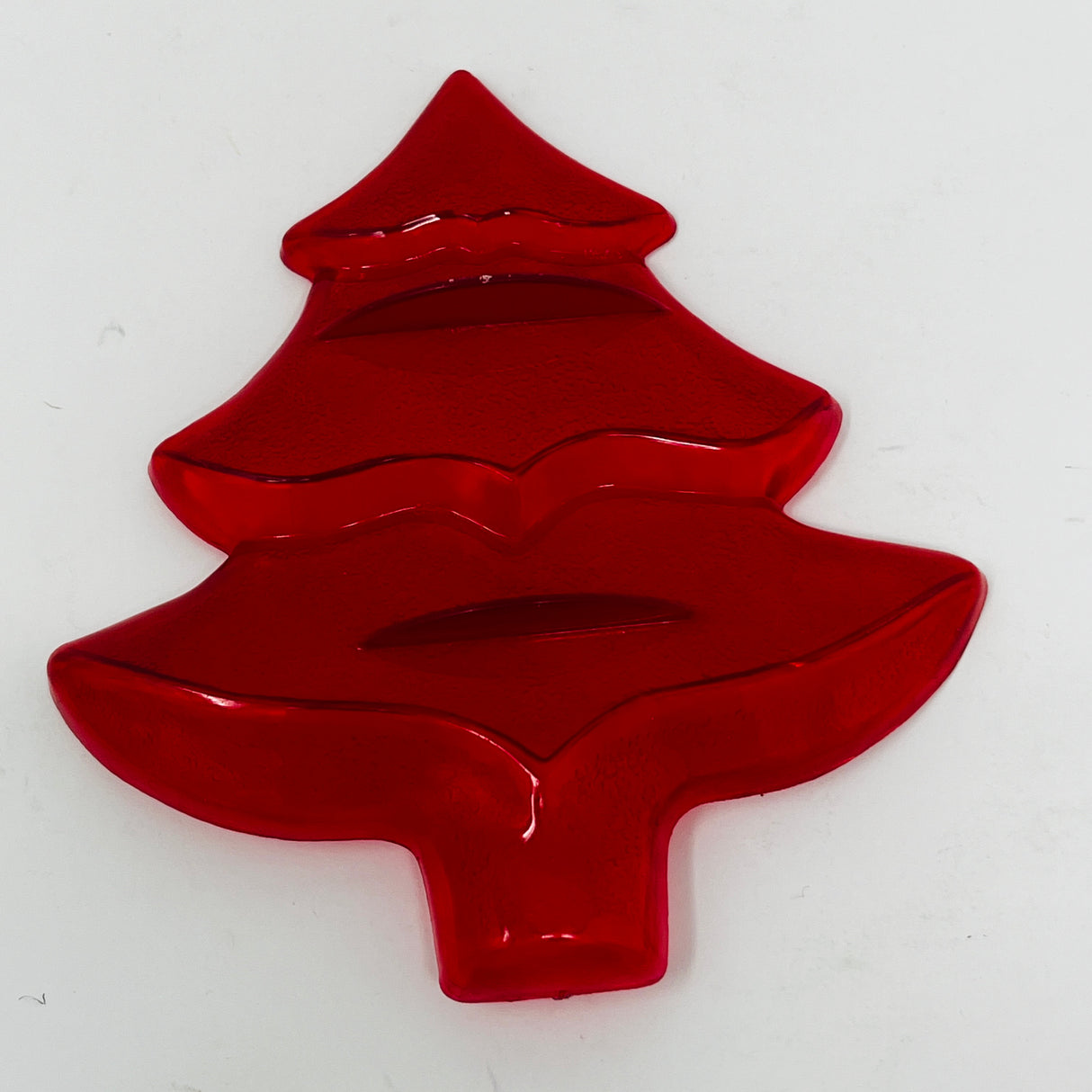 Red plastic mid century cookie cutters, some with Crown logo, in various shapes like a Christmas tree.