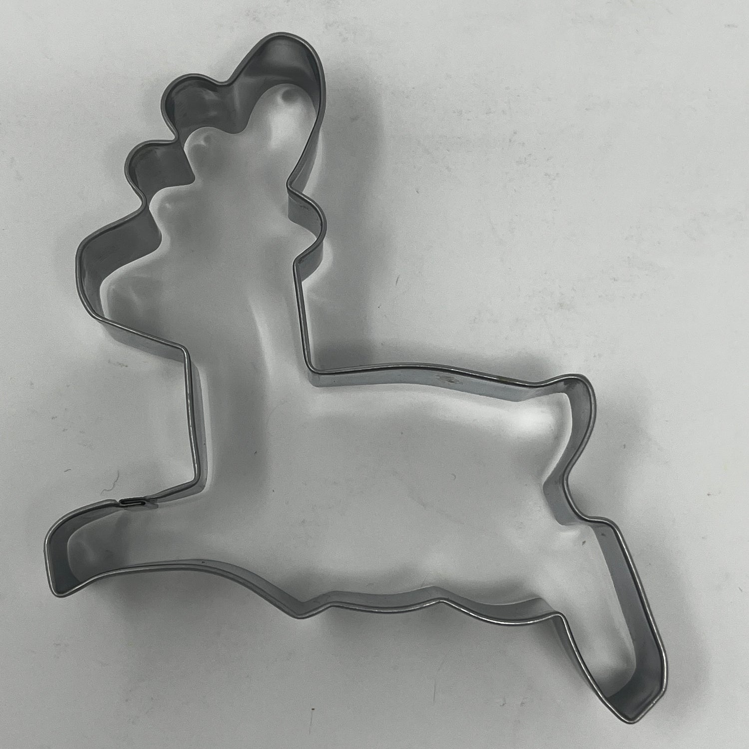 Mid-century metal cookie cutters featuring adaptive designs with large handles, showcasing Christmas and celestial shapes, including rare 1930s Pillsbury Comicooky Cutter.