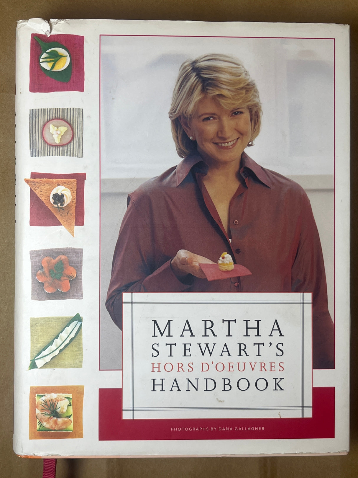 Cover of Martha Stewart’s Hors d’Oeuvres Handbook featuring Martha Stewart holding an hors d’oeuvre, with small vignettes of various appetizers along the left.